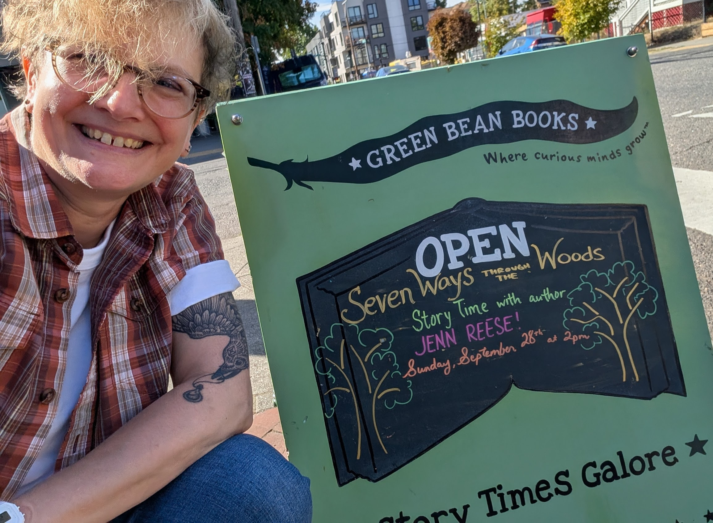 Me posing next to a sign announcing my event. 
